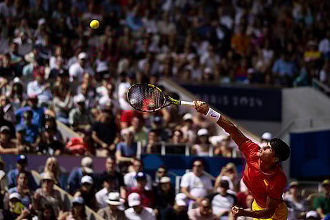 Carlos Alcaraz serves to Serbia's Novak Djokovic